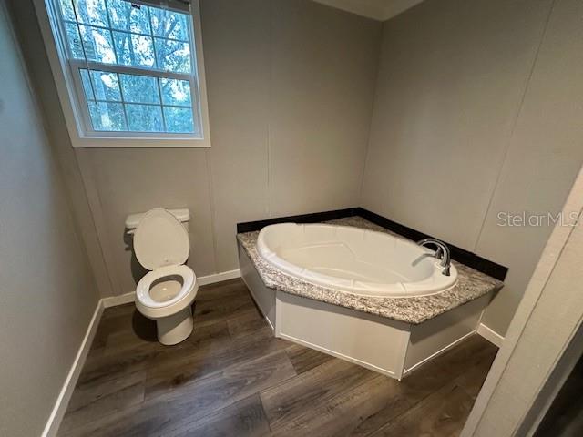 374 Sisco Road Pomona Park, FL 32181 - Photo 46 of 51 a bathroom with a granite countertop toilet and a sink