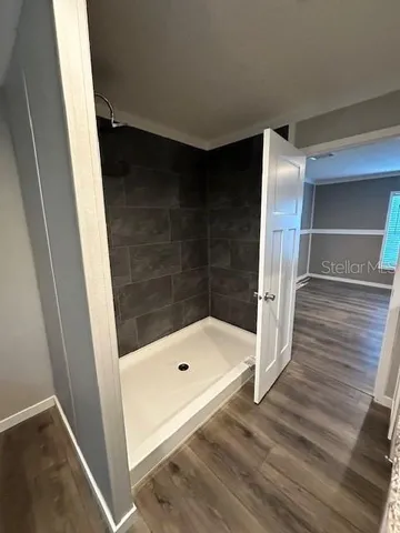 a bathroom with a tub and shower