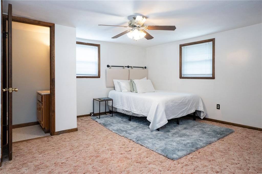 10 North Street Atlasburg, PA 15004 - Photo 17 of 27 a spacious bedroom with a bed and a ceiling fan
