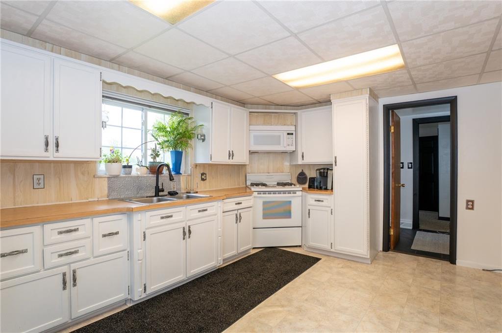 10 North Street Atlasburg, PA 15004 - Photo 4 of 27 a kitchen with white cabinets and white appliances