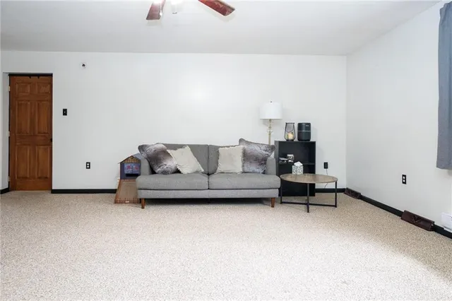 a living room with furniture and a lamp