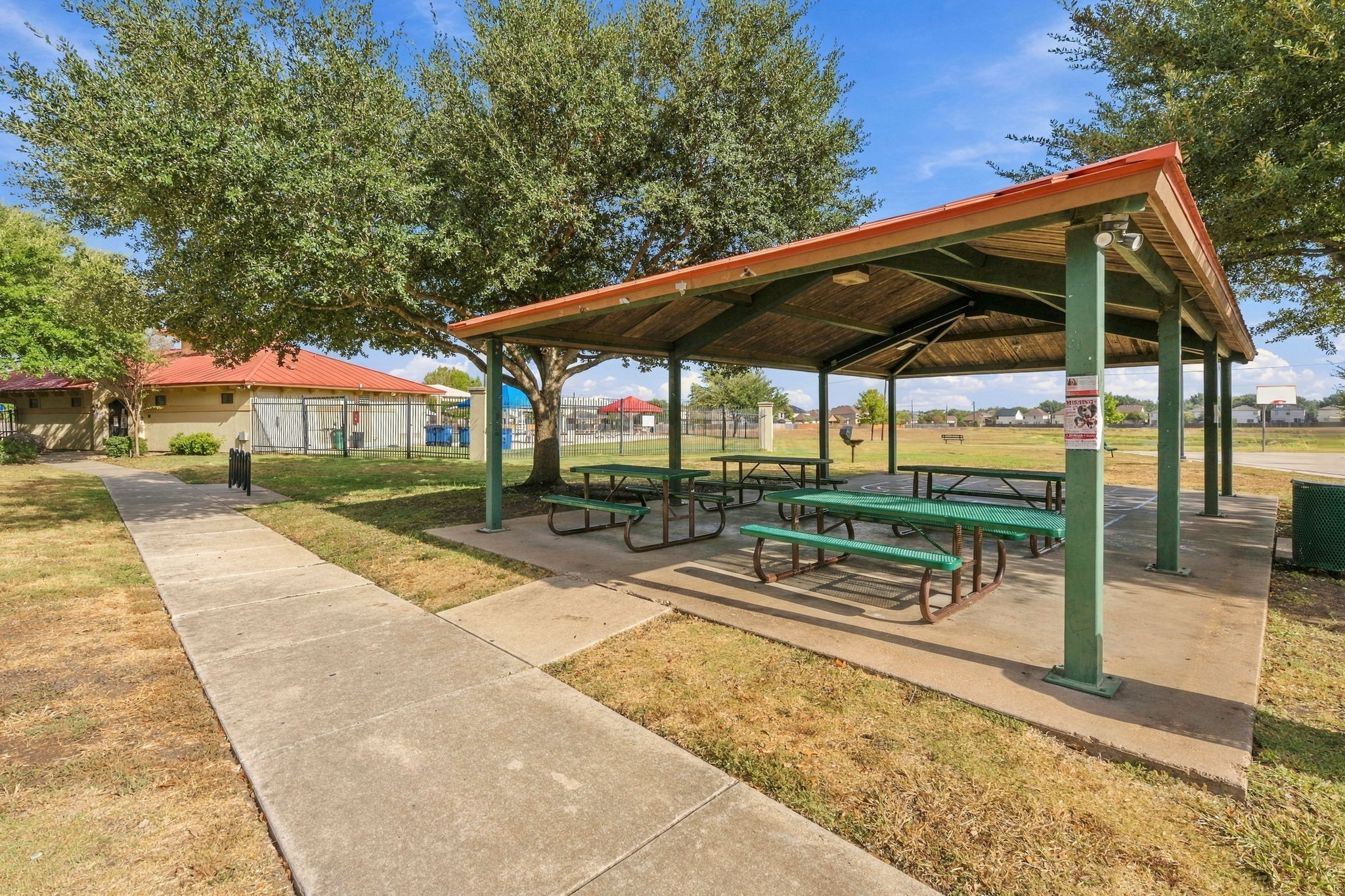 9004 Wiley Way Austin, TX 78747 - Photo 35 of 39 A spacious covered pavilion provides a shady outdoor gathering spot alongside concrete walking paths.