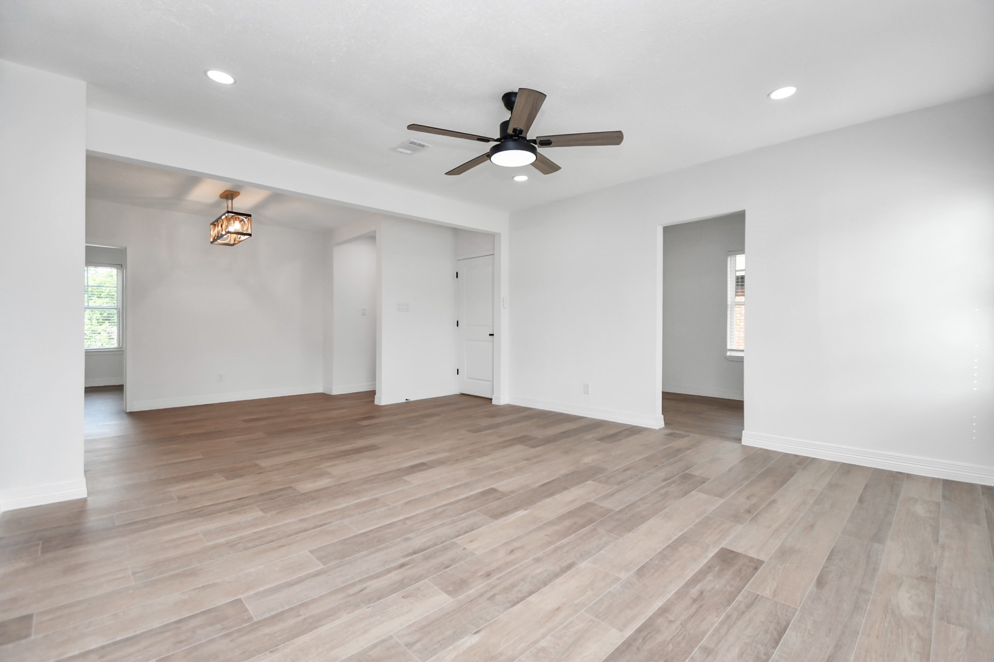 2812 Truxillo Street, Unit B Houston, TX 77004 - Photo 11 of 32 wooden floor in an empty room with a window
