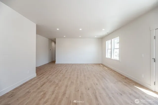 an empty room with a empty space and windows