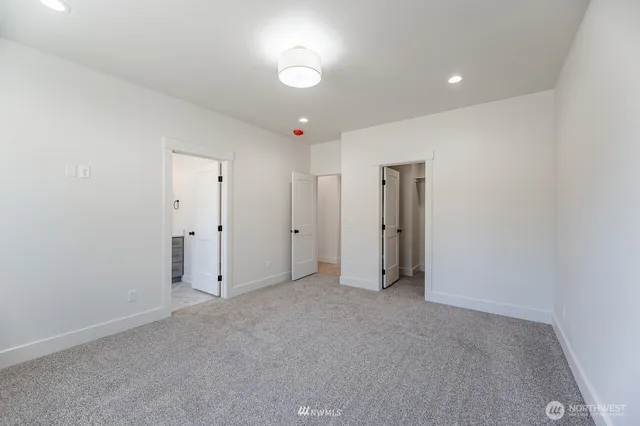 a bathroom with a double vanity sink and mirror with window