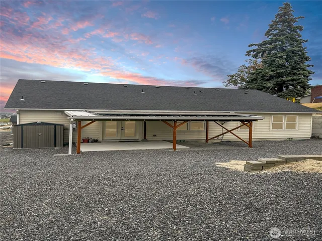 a view of a hallway with wooden floor and a chandelier