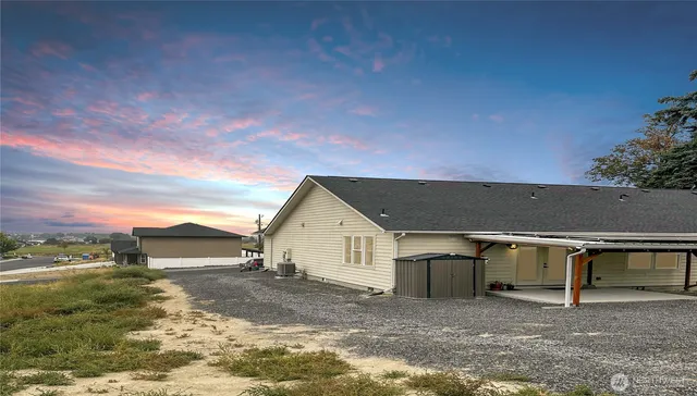 a view of backyard with small cabin and wooden fence