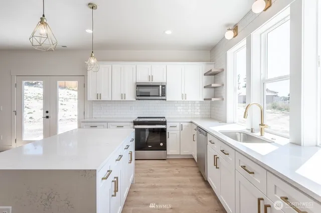 a kitchen with a stove a sink and a refrigerator