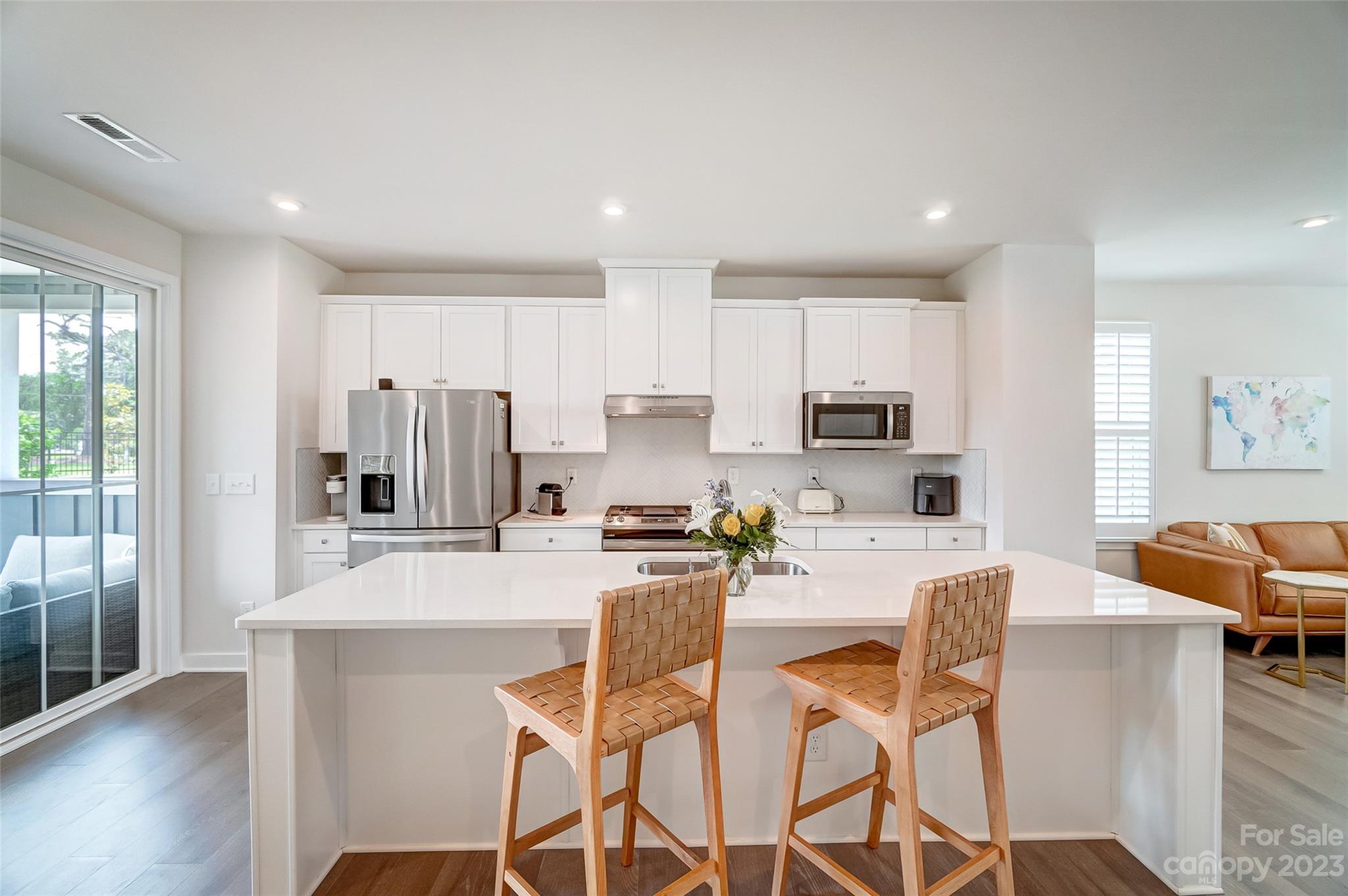 636 Crudent Road Tega Cay, SC 29708 - Photo 11 of 45 a kitchen with stainless steel appliances kitchen island granite countertop a refrigerator and microwave