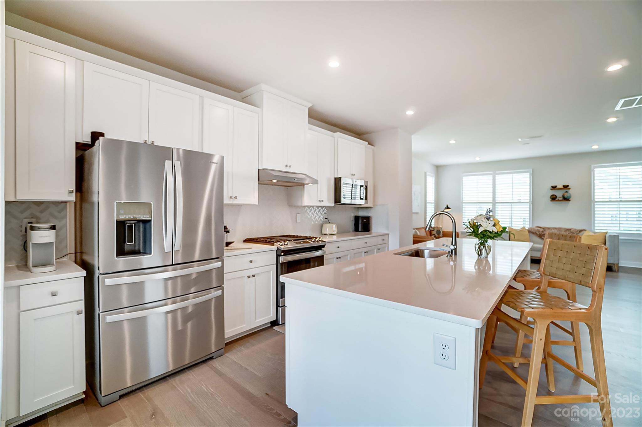 636 Crudent Road Tega Cay, SC 29708 - Photo 13 of 45 a kitchen with stainless steel appliances granite countertop a refrigerator a stove a sink a dining table and chairs