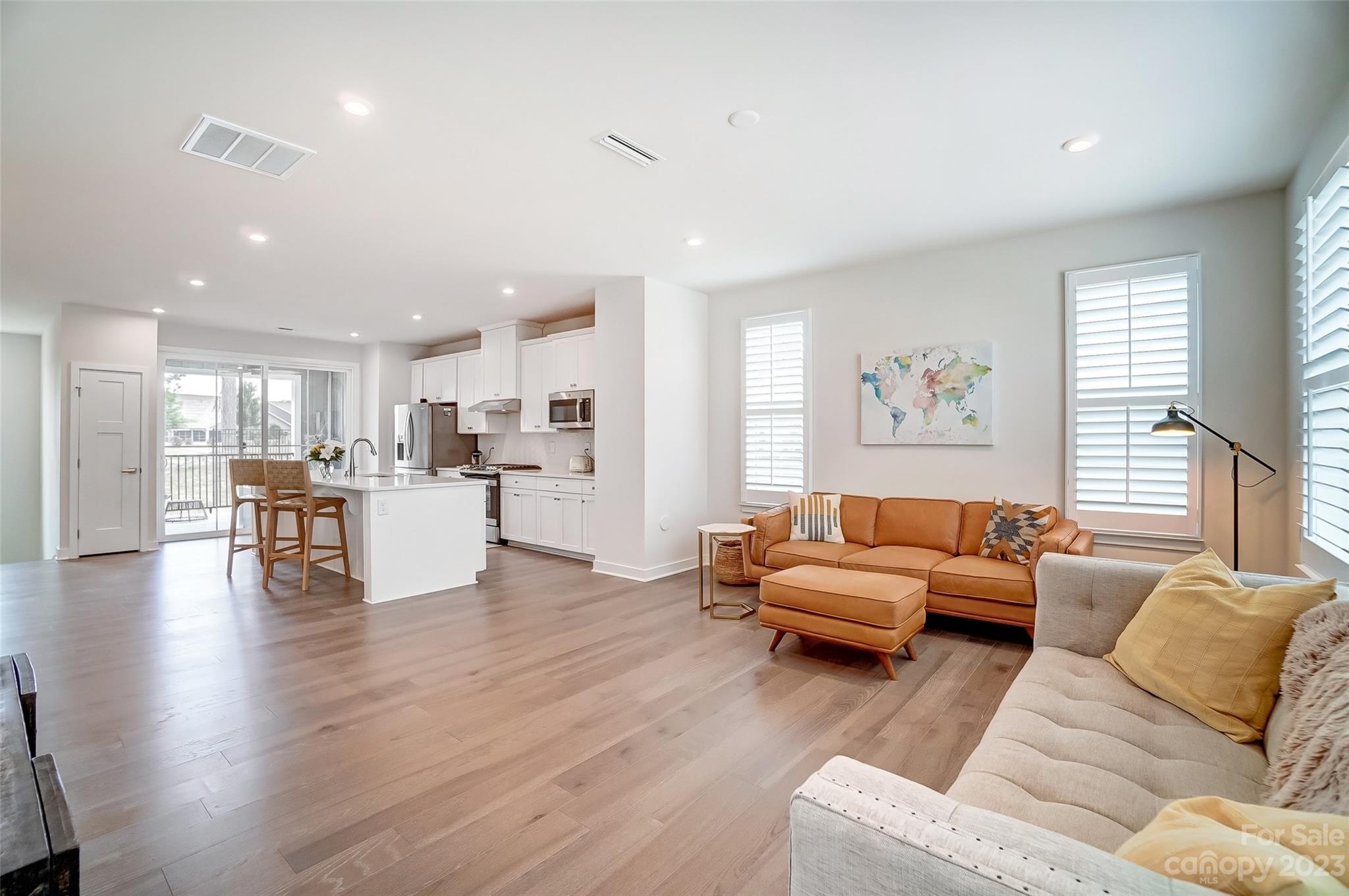 636 Crudent Road Tega Cay, SC 29708 - Photo 18 of 45 a living room with furniture and kitchen view with wooden floor