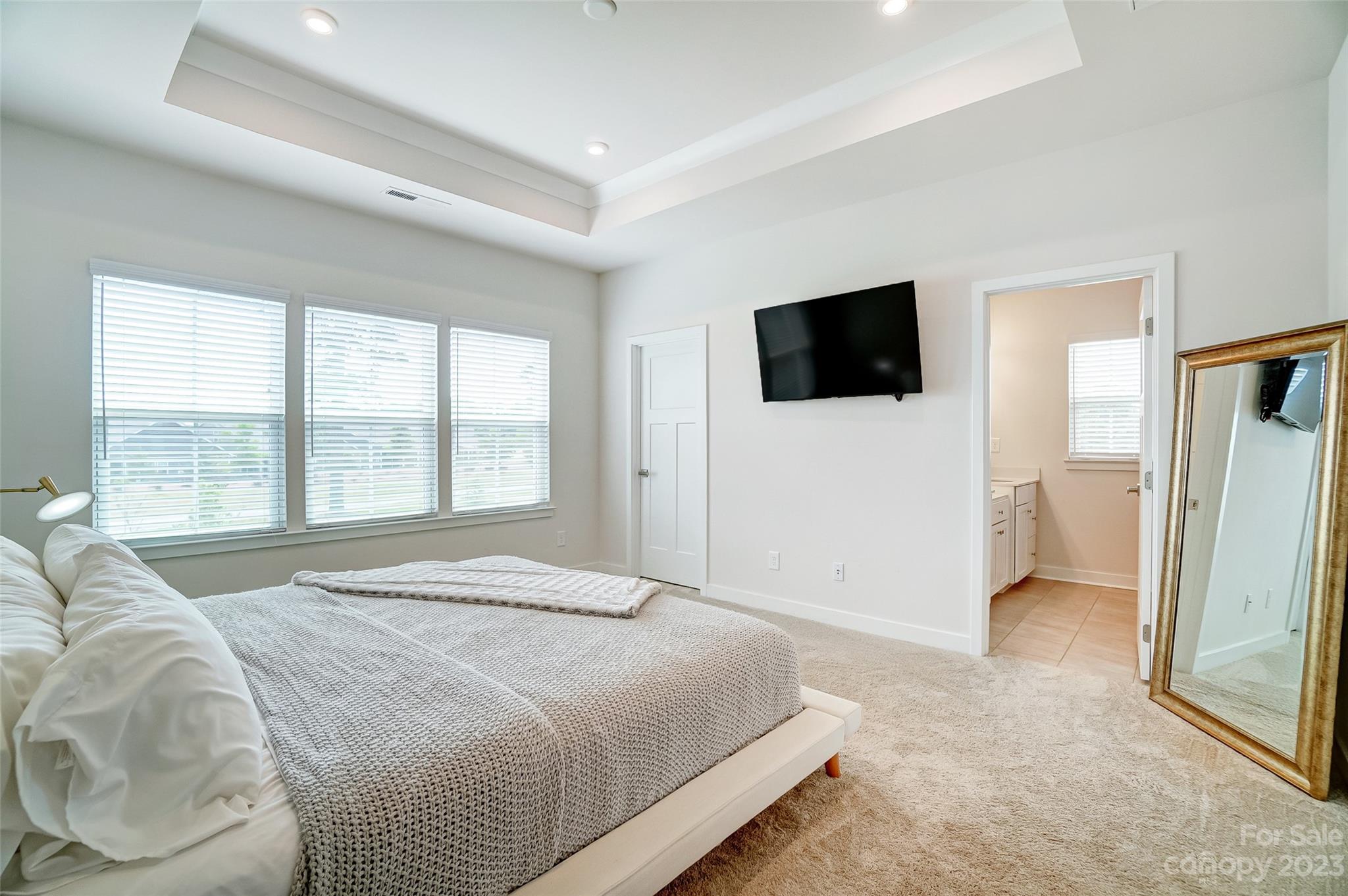 636 Crudent Road Tega Cay, SC 29708 - Photo 27 of 45 a spacious bedroom with a large bed and a flat screen tv
