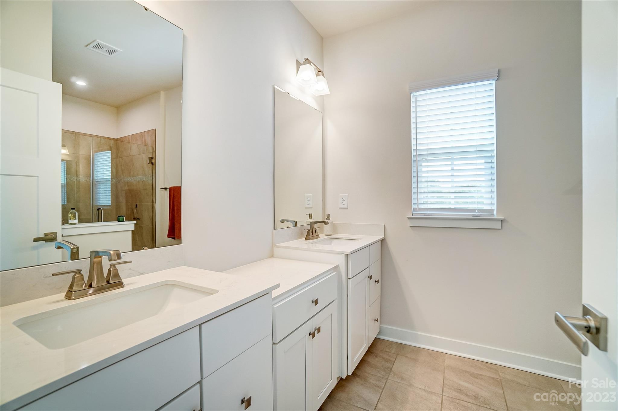 636 Crudent Road Tega Cay, SC 29708 - Photo 30 of 45 a bathroom with a sink double vanity and a mirror