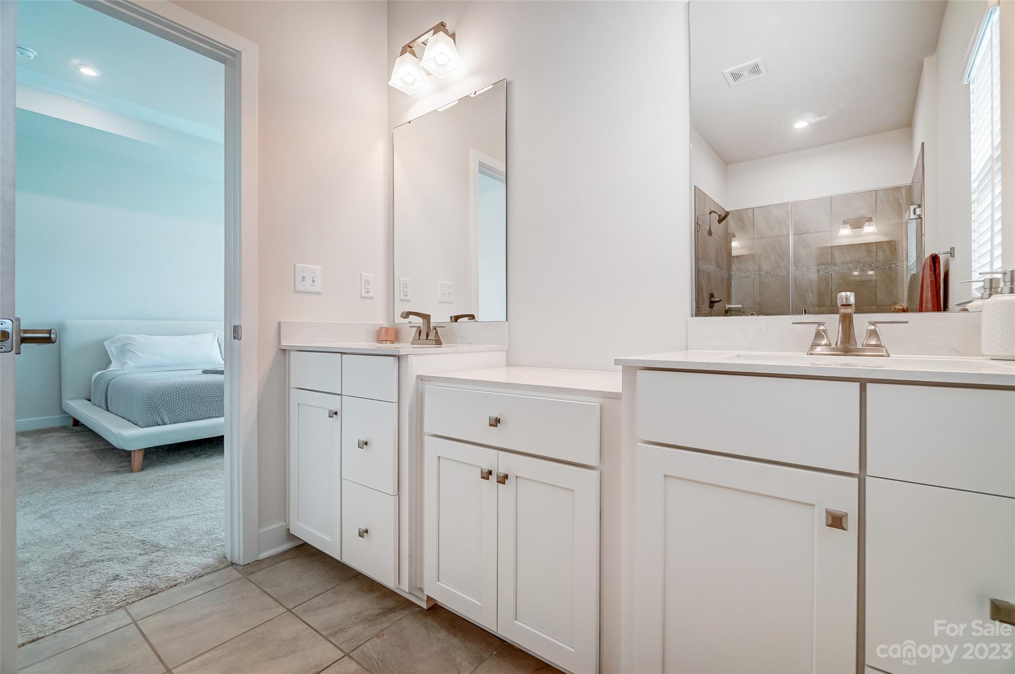 636 Crudent Road Tega Cay, SC 29708 - Photo 33 of 45 a en suite bathroom with a double vanity sink and mirror