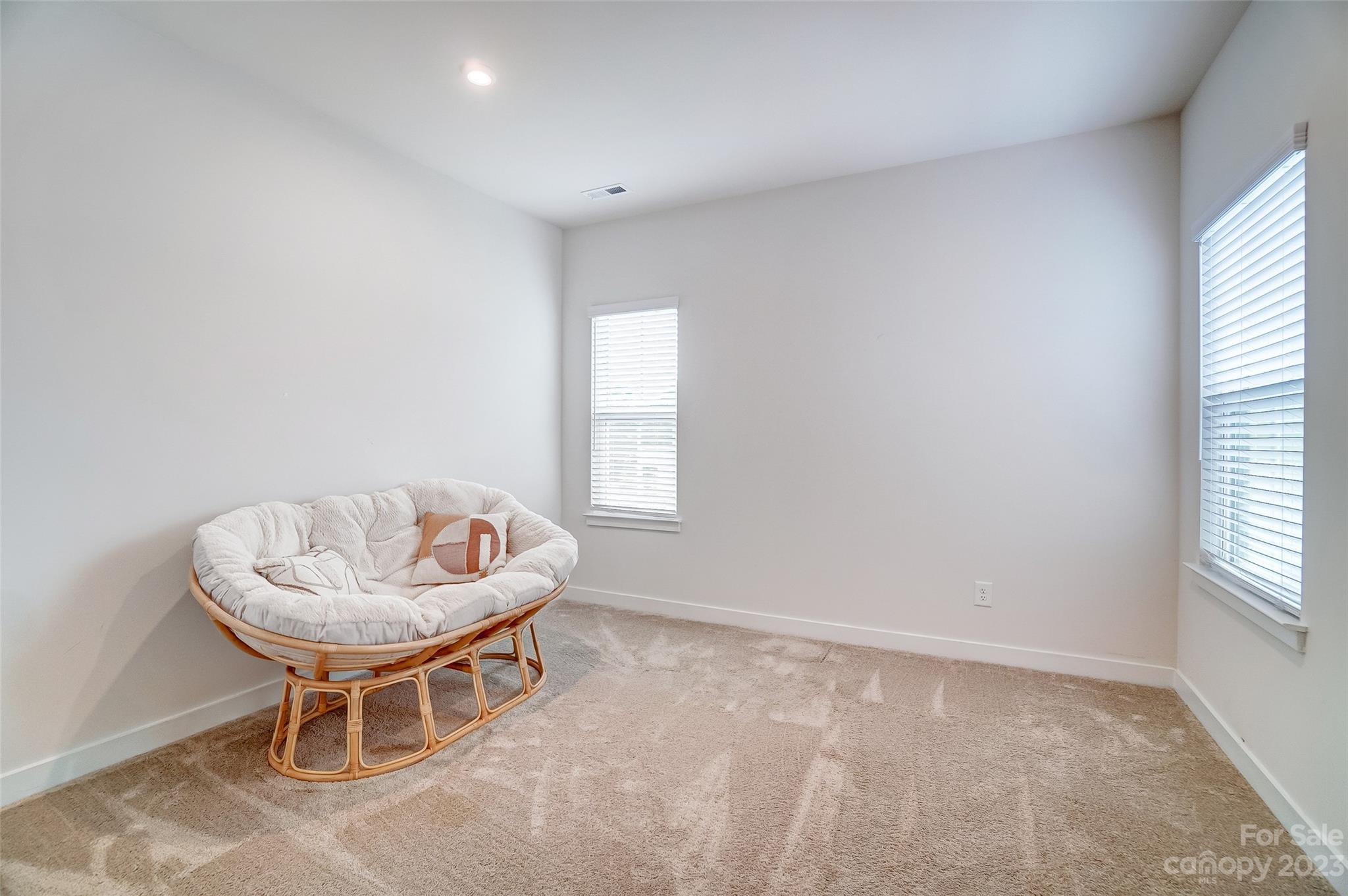 636 Crudent Road Tega Cay, SC 29708 - Photo 34 of 45 an empty room with windows and chair