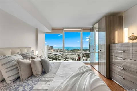a large bedroom with a large bed and a large window