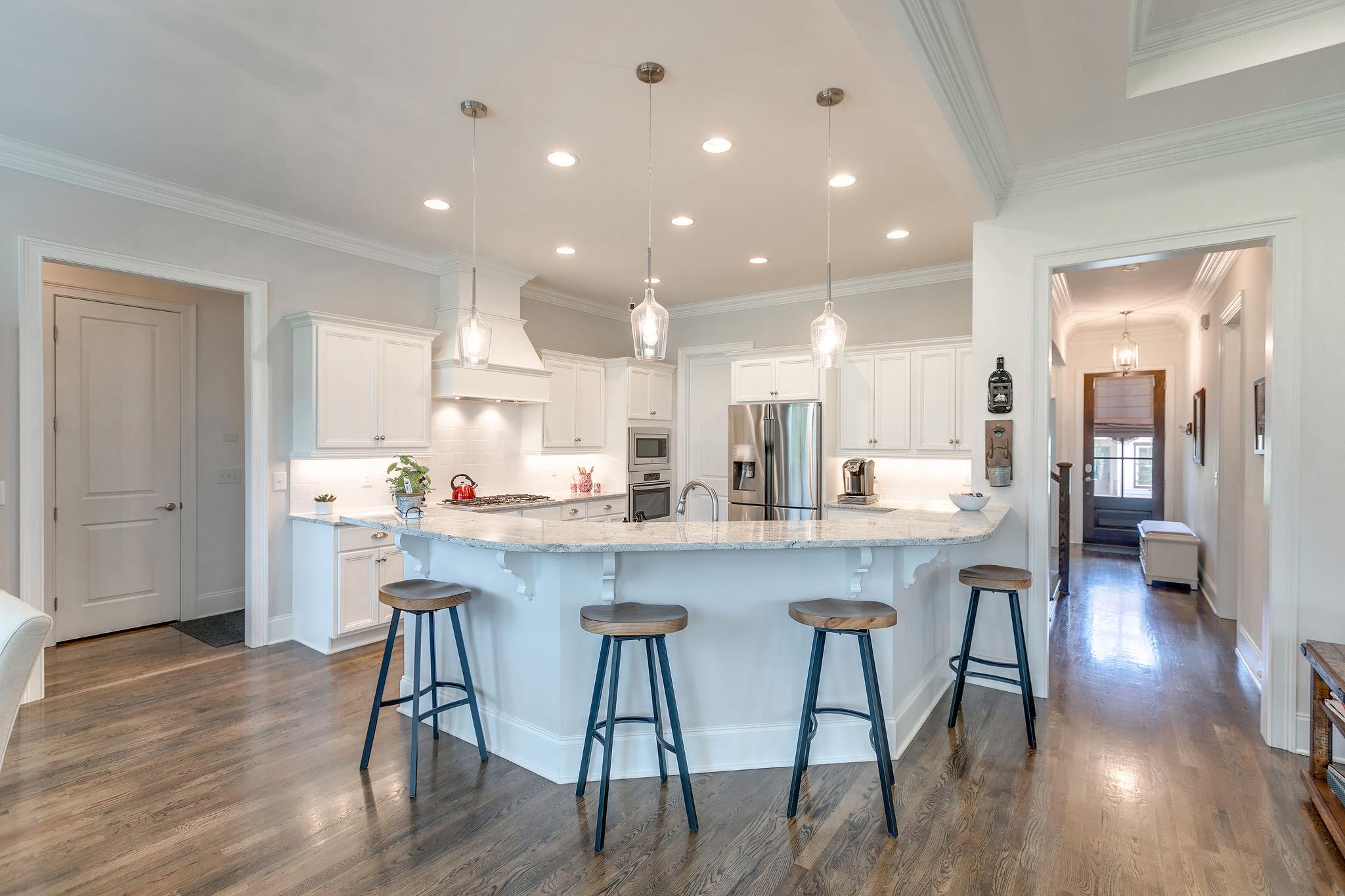 430 Alfred Ladd Road East Franklin, TN 37064 - Photo 13 of 30 Pretty kitchen featuring white cabinets. granite counters, stainless steel appliances and pantry.