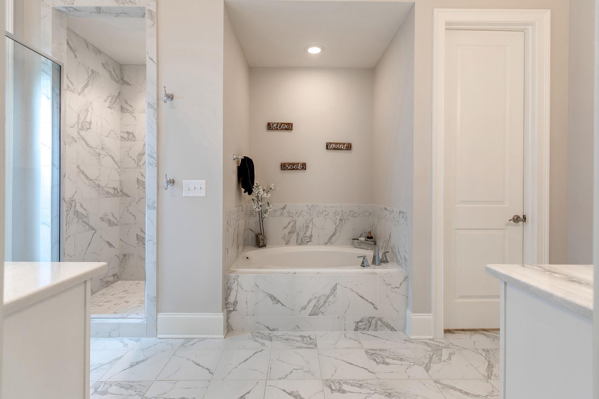 430 Alfred Ladd Road East Franklin, TN 37064 - Photo 19 of 30 Grand master bath with pretty tiled shower, separate tub, his and her vanities-all neutral decor.