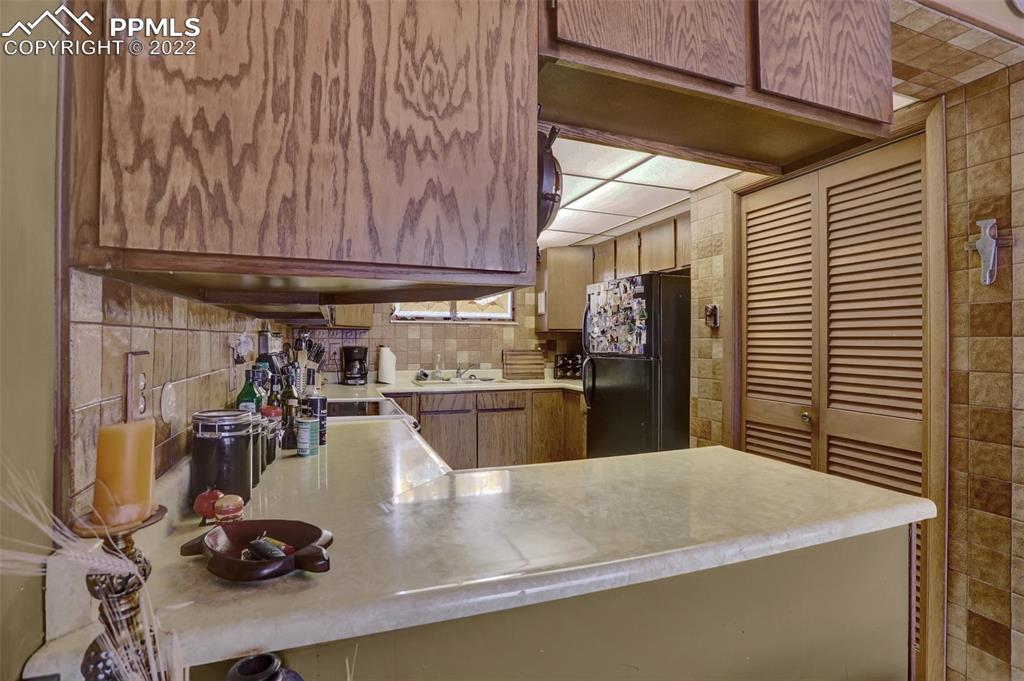 756 Spring Valley Drive Divide, CO 80814 - Photo 14 of 50 a kitchen with a sink and cabinets
