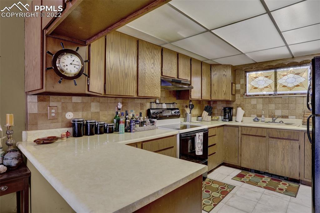 756 Spring Valley Drive Divide, CO 80814 - Photo 15 of 50 a kitchen with sink cabinets and window