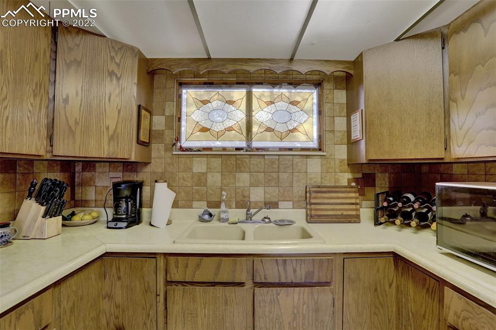 756 Spring Valley Drive Divide, CO 80814 - Photo 17 of 50 a kitchen with a sink a counter and cabinets