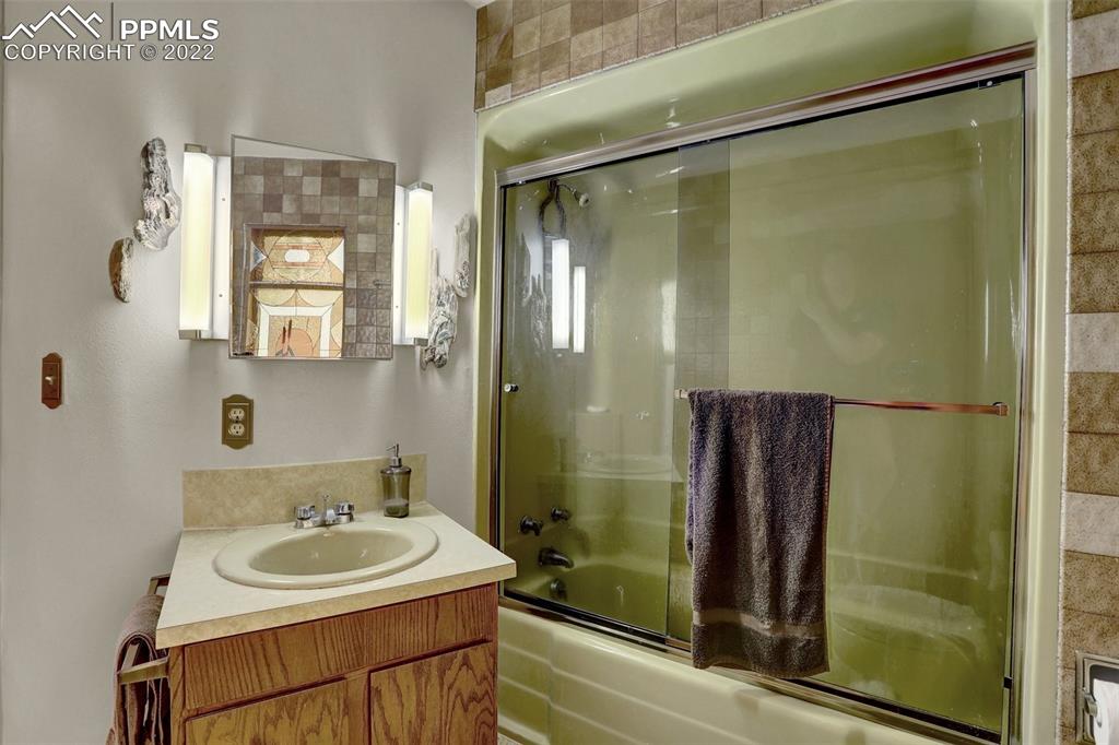 756 Spring Valley Drive Divide, CO 80814 - Photo 28 of 50 a bathroom with a sink and a mirror