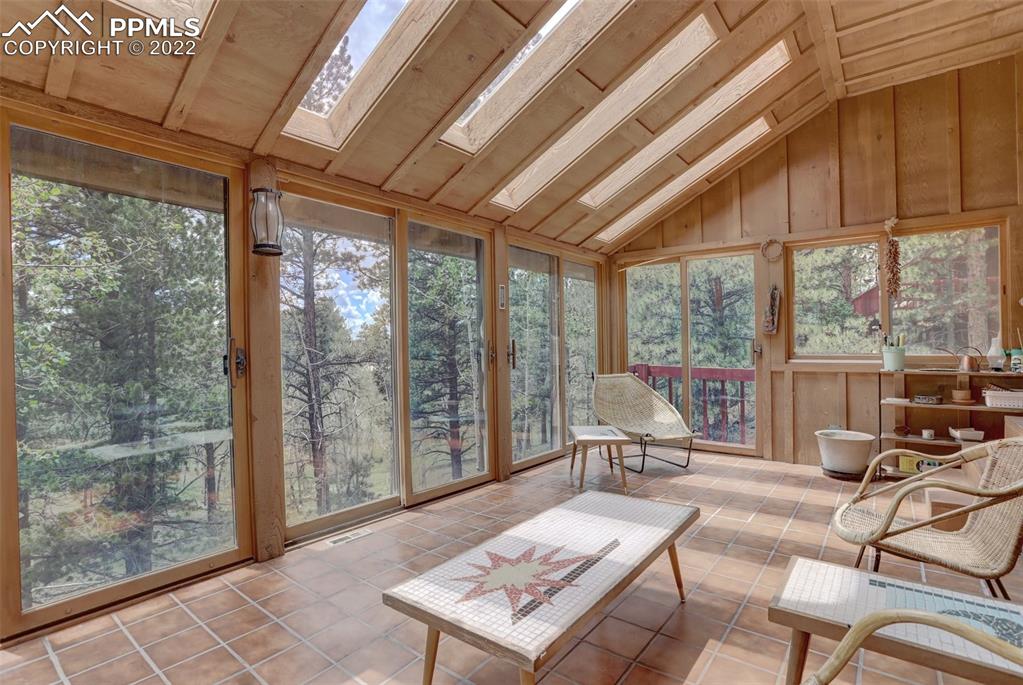 756 Spring Valley Drive Divide, CO 80814 - Photo 44 of 50 a living room with furniture and a floor to ceiling window