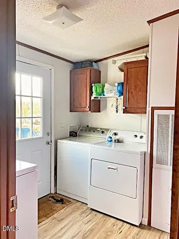 a room with a sink cabinets and appliances