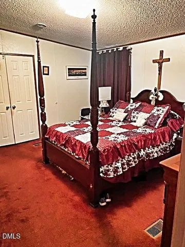 a bedroom with bed and dresser