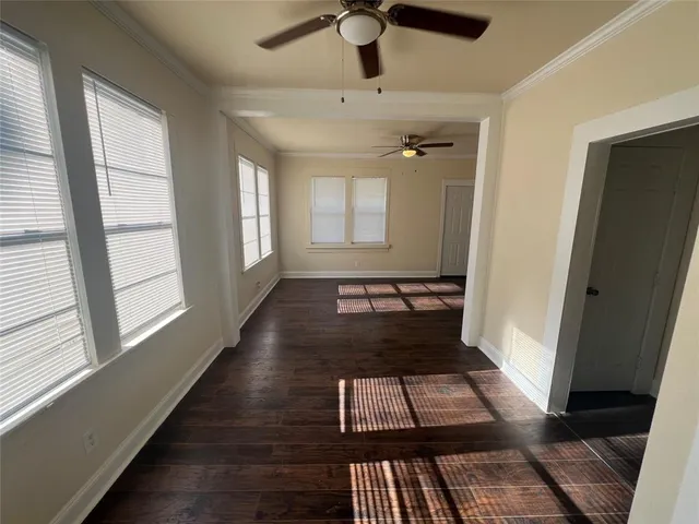 wooden floor in a hall with wooden floor and a window