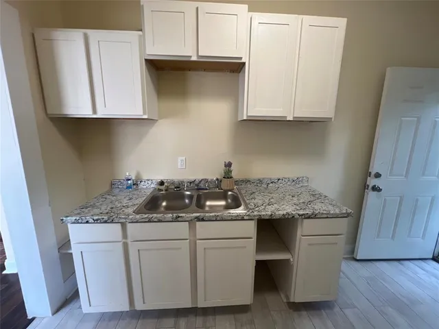 a kitchen with stainless steel appliances granite countertop a sink stove and cabinets