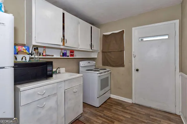 a kitchen with a sink cabinets and stainless steel appliances