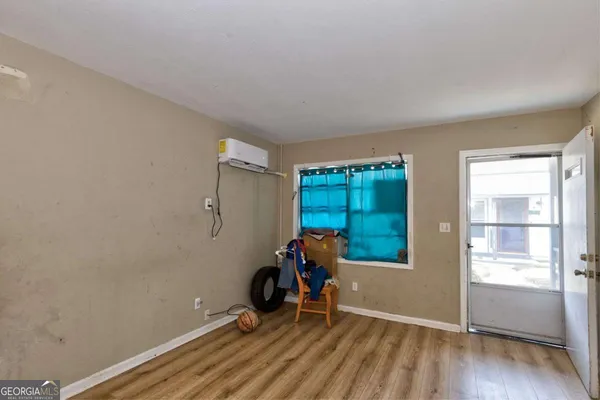 an empty room with furniture and wooden floor