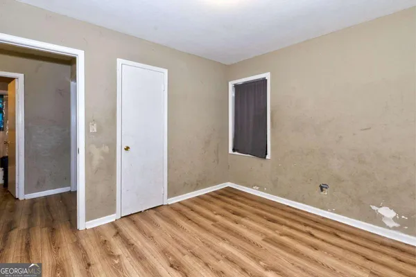 a view of a room with wooden floor and bathroom