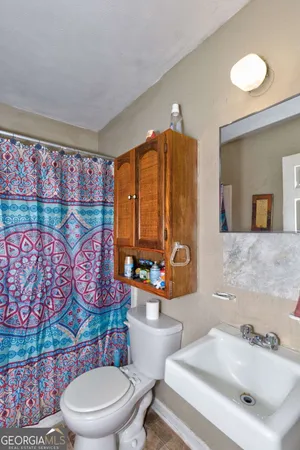 a bathroom with a sink mirror vanity and toilet