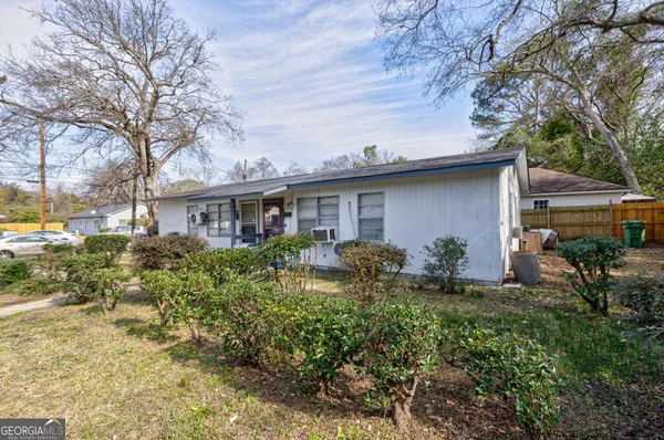 a front view of house with a garden