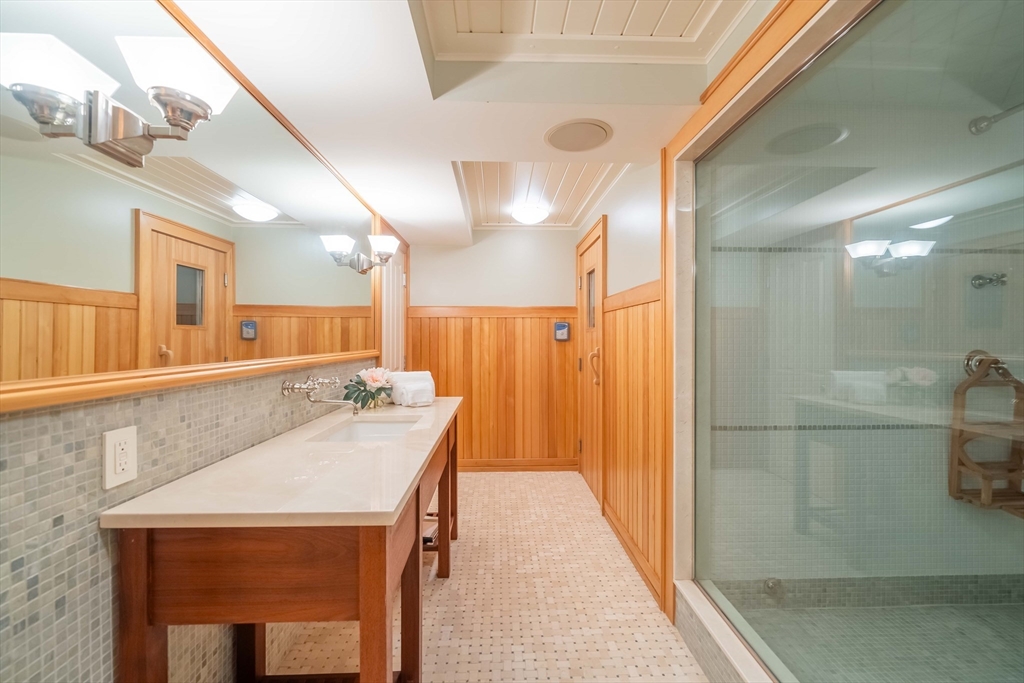 197 Grant Street Lexington, MA 02420 - Photo 33 of 42 a bathroom with a sink a mirror and a shower