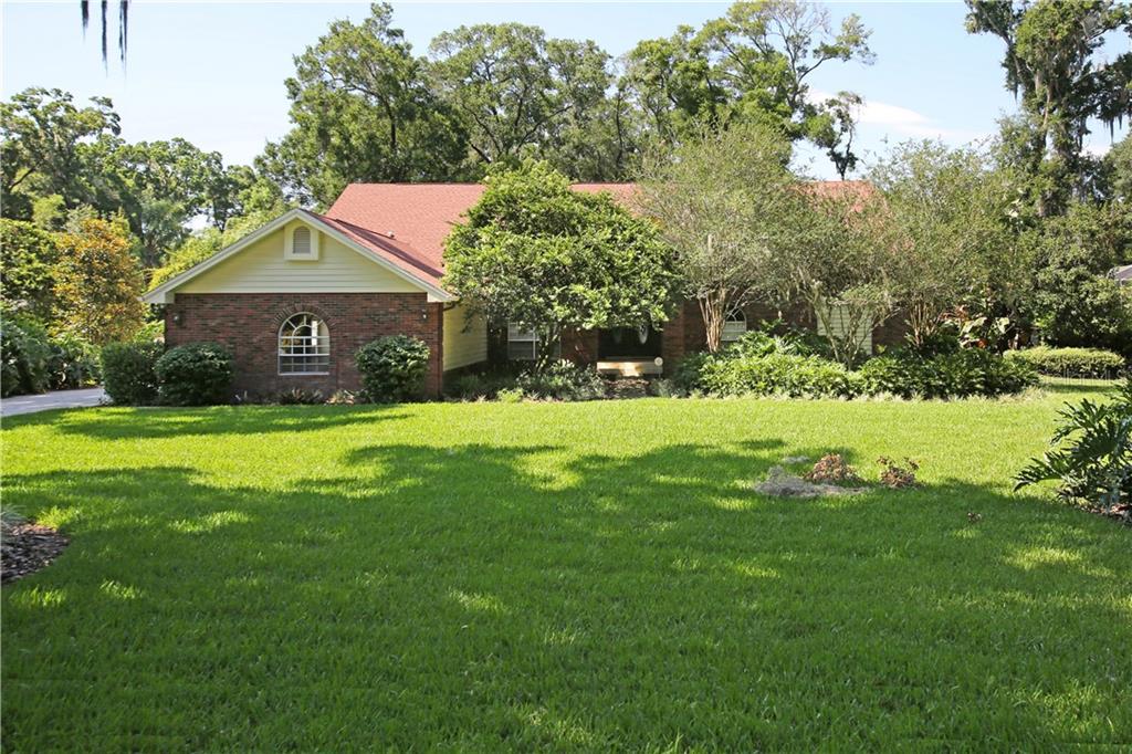 a front view of house with yard and green space