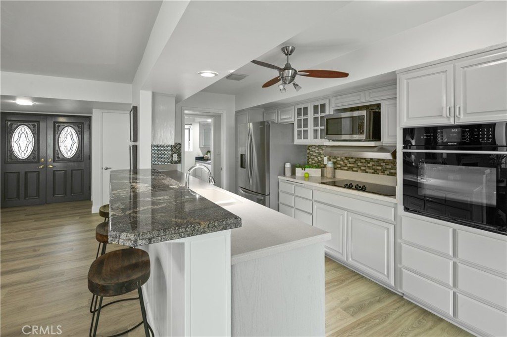 2805 Chillon Way Laguna Beach, CA 92651 - Photo 8 of 41 a kitchen with stainless steel appliances granite countertop a sink a stove and cabinets