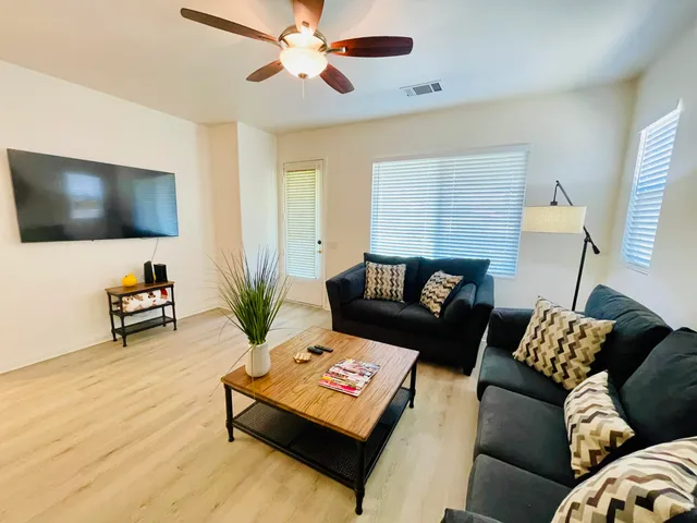 a living room with furniture and a clock