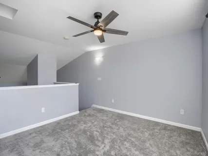 a view of a living room with furniture and wooden floor