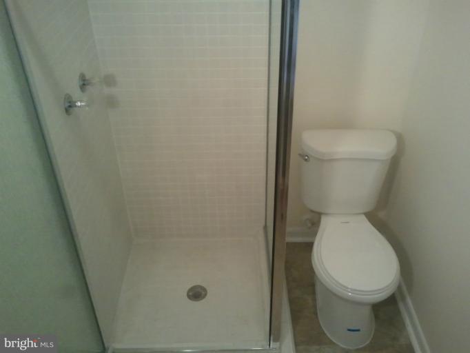 790 Charing Cross Road Baltimore, MD 21229 - Photo 7 of 14 a white toilet sitting next to a shower