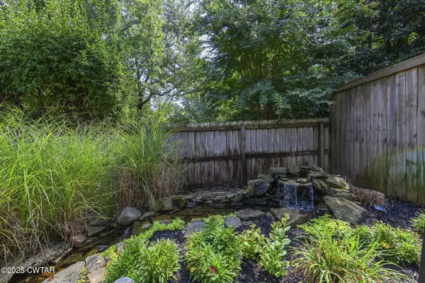 a living room with furniture a fireplace and a table