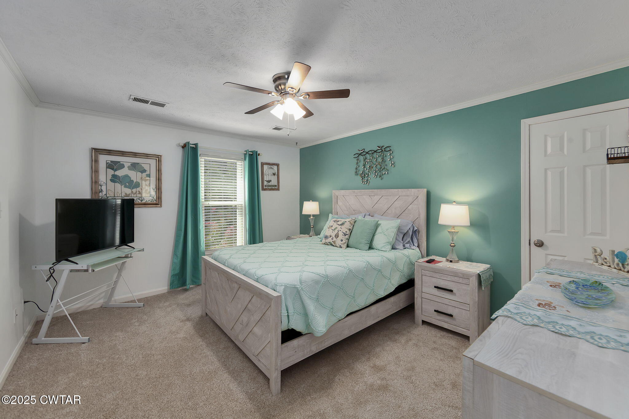 160 Plantation Road Jackson, TN 38305 - Photo 25 of 50 a bedroom with a bed and a flat tv screen on dresser