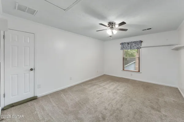a view of a house with a yard and large trees
