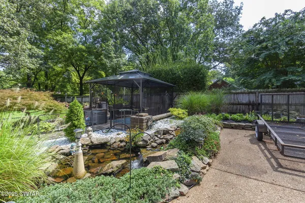 a view of a patio with couches chairs and a big yard