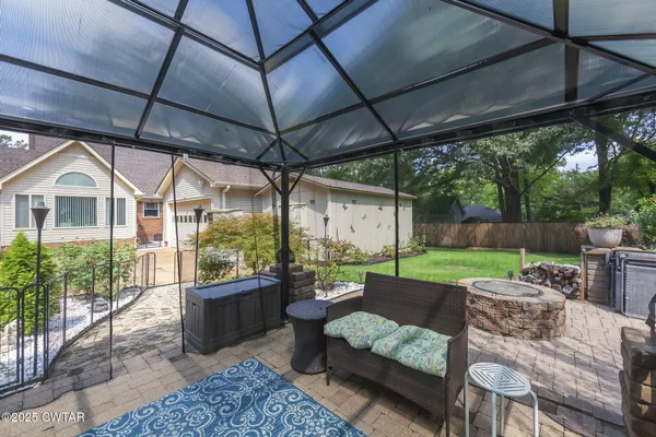 a view of a porch with furniture and a floor to ceiling window