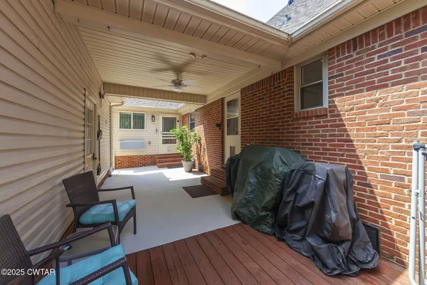an aerial view of a house with a yard and outdoor seating