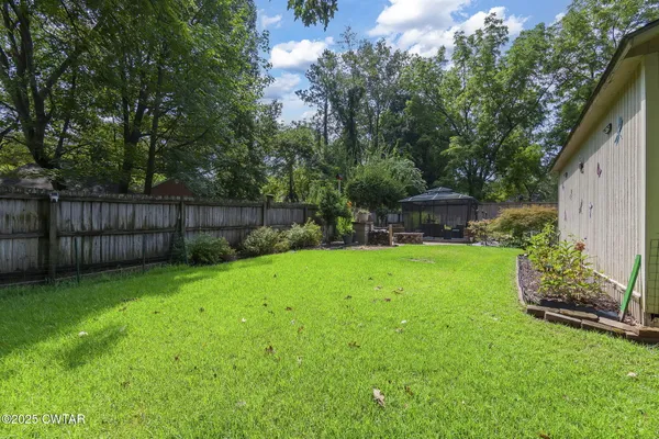 a backyard of a house with yard and outdoor seating