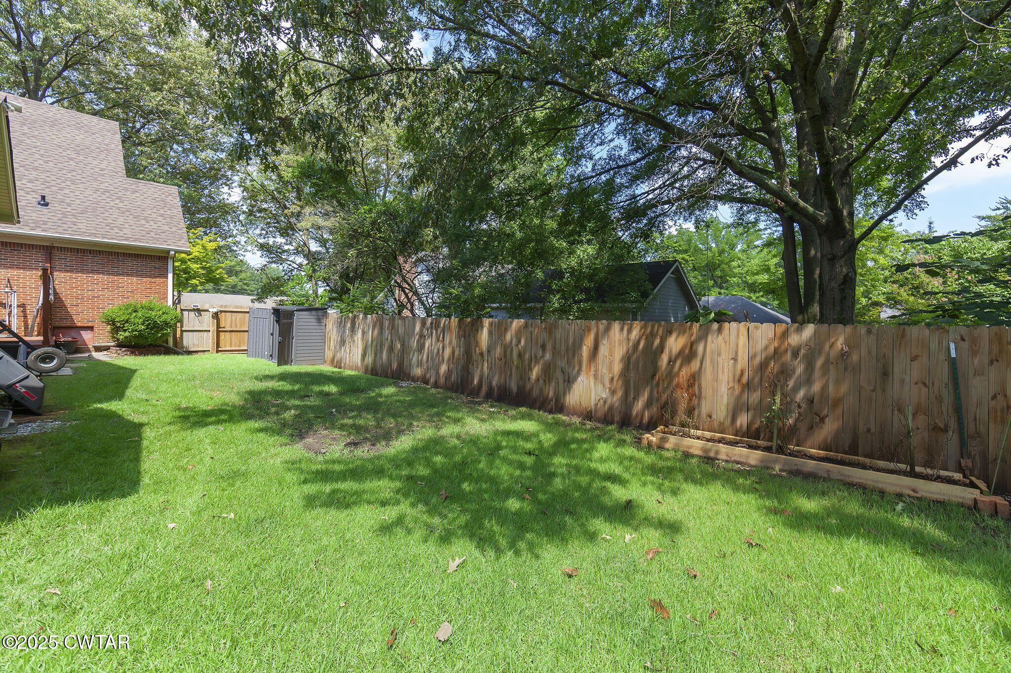 160 Plantation Road Jackson, TN 38305 - Photo 44 of 50 a view of a backyard with a garden and tree